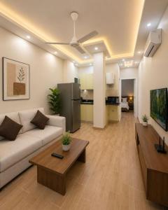 a living room with a couch and a table at جراند فاندا سويتس الغردقه Grand Vanda Suites Hurghada in Hurghada