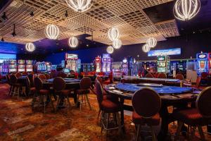 a casino with tables and chairs and poker machines at Marriott Isla Verde Beach Resort in Carolina