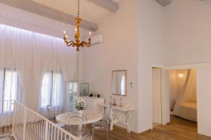 a dining room with a table and a chandelier at Villa Mirandola in Mirandola