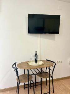 a wooden table with two chairs and a bottle of wine at Marica & Kata in Vrgorac