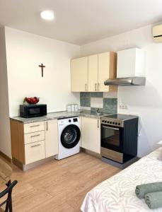 a kitchen with a washer and dryer in a room at Marica & Kata in Vrgorac +3 photos