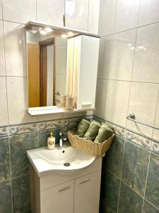 a bathroom with a sink and a mirror at Marica & Kata in Vrgorac