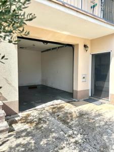 a garage with an open door in a building at Marica & Kata in Vrgorac