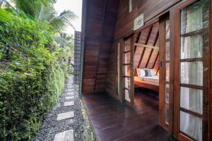 a hallway of a house with a bed in it at Medukuh Point Hill in Karangasem