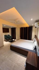 a bedroom with a large bed in a room at hotel celebrations in Jāmb