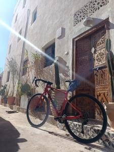 a red bike parked in front of a building at Moroccan Boho Surf House in Agadir