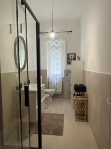 a bathroom with a sink and a toilet and a mirror at AuraHouse in Mignanego