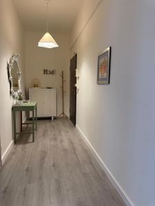 an empty room with a table and a hallway at AuraHouse in Mignanego +4 photos