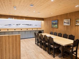a conference room with a wooden table and chairs at Karstenstua in Holo
