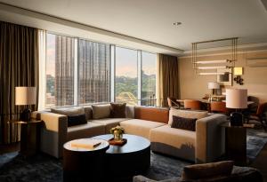 a living room with a couch and a large window at Fairmont Pittsburgh in Pittsburgh +147 photos