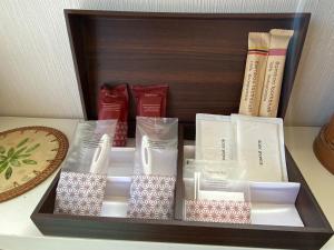 a wooden box with books on a table at Beach House Bellissima ! in Yomitan