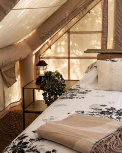 a bedroom with a bed and a large window at THOUARS Rivière LODGE KAËLI in Maulais +56 photos