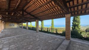 an outdoor patio with a wooden pergola at B&B Dimora Aura in Cupra Marittima