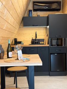 a kitchen with a table with wine glasses on it at Lune Dunakanyar in Esztergom