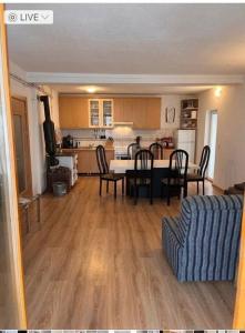 a living room with a table and chairs and a kitchen at Mountain View Retreat near Pelister National Park, Huge Garden, Hiking Paradise in Nižepole