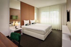 a hotel room with a large bed and a television at Van der Valk Zaltbommel-A2 in Zaltbommel +44 photos