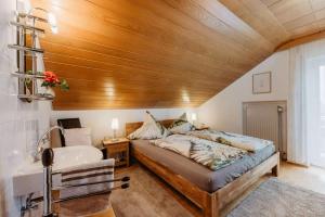 a bedroom with a large bed and a sink at Haus Heidi in Freyung