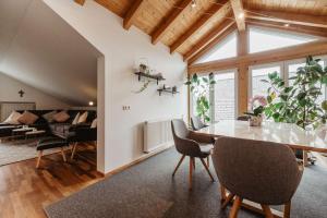 a living room with a table and chairs and a couch at Haus Heidi in Freyung +26 photos
