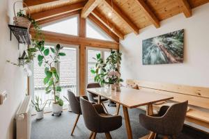 a dining room with a wooden table and chairs at Haus Heidi in Freyung