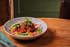 a bowl of food on top of a wooden table at The Ullswater Inn- The Inn Collection Group in Glenridding