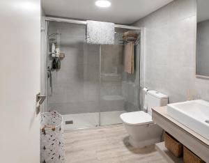 a bathroom with a shower and a toilet and a sink at Festasol - Apartament Estartit in Torroella de Montgrí