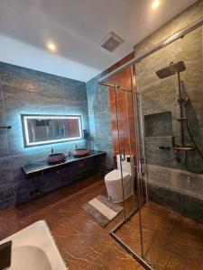 a bathroom with a shower and a toilet and a sink at 185 HomeStay Chiangmai 185 โฮมสเตย์ เชียงใหม่ in Hang Dong +45 photos