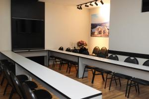 a conference room with chairs and a long table at Hotel Rezende in Lambari
