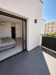 a bedroom with a bed on a balcony at Villa 280 m2 in Sète