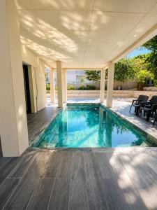 a swimming pool in the middle of a house at Villa 280 m2 in Sète