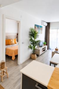 a bedroom with a bed and a living room at Festasol - Apartament Estartit in Torroella de Montgrí