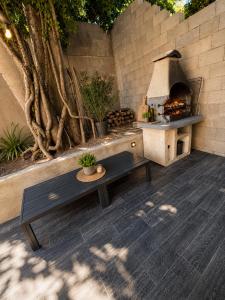 a patio with a table and a pizza oven at Villa 280 m2 in Sète