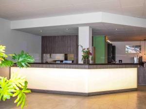 a lobby with a counter with a kitchen in it at B&B HOTEL Dresden-Altstadt in Dresden