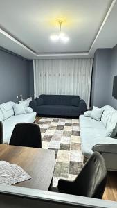 a living room with two couches and a table at Arden home in Van