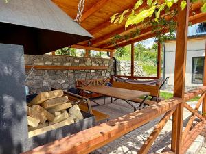 a wooden patio with a table and a bench at Mountain Symphony House Dilijan in Dilijan