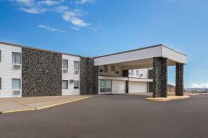 a rendering of a building with a garage at Days Inn by Wyndham Mandan Bismarck Area in Mandan