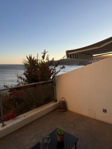 a patio with a table and a view of the ocean at GuestReady - Beachfront Studio in Sesimbra