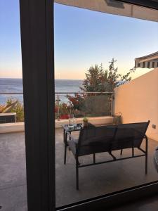 a patio with a table and a view of the ocean at GuestReady - Beachfront Studio in Sesimbra +36 photos