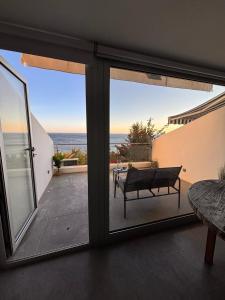 a view of the ocean from a room with sliding glass doors at GuestReady - Beachfront Studio in Sesimbra