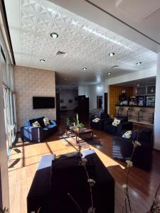 a large living room with couches and a tv at Estrela Palace Hotel in Estrêla
