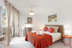 a bedroom with a bed with a red blanket at Suite Sainte-Hélène FSHH in Nice