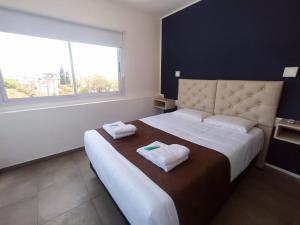a bedroom with a large bed with towels on it at Hotel Astoria in Villa Carlos Paz +15 photos