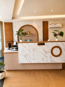 an office lobby with a marble counter top at The hotel golden crown in Baddi