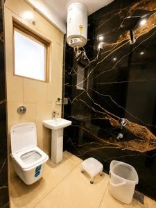 a bathroom with a toilet and a sink at The hotel golden crown in Baddi
