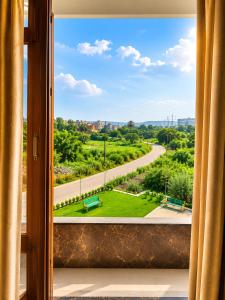 a view from a window of a park at The hotel golden crown in Baddi