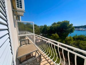 a balcony with a bench and a view of the water at Apartments Mustel Drage - Adults Only in Drage +22 photos