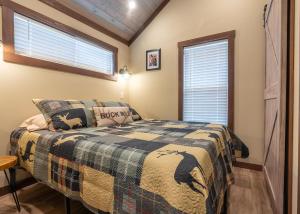 a bedroom with a bed and a window at Deers Den River- Luxury Tiny Home on River in Bryson City