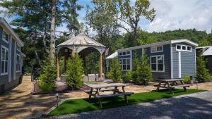 a picnic table and a gazebo in a yard at Deers Den River- Luxury Tiny Home on River in Bryson City