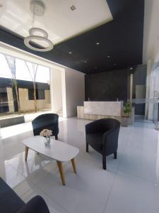 a living room with two chairs and a table at Hotel Astoria in Villa Carlos Paz