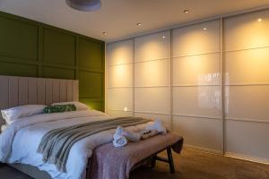 a bedroom with a large bed with green walls at Sundale House in Lurgan