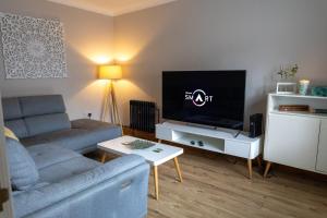 a living room with a couch and a flat screen tv at Sundale House in Lurgan
